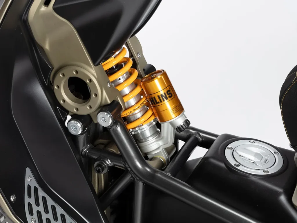 前悬吊系统的 Ohlins 单避震设置于双脚之间,油箱则配置于钢管编织车架之间。